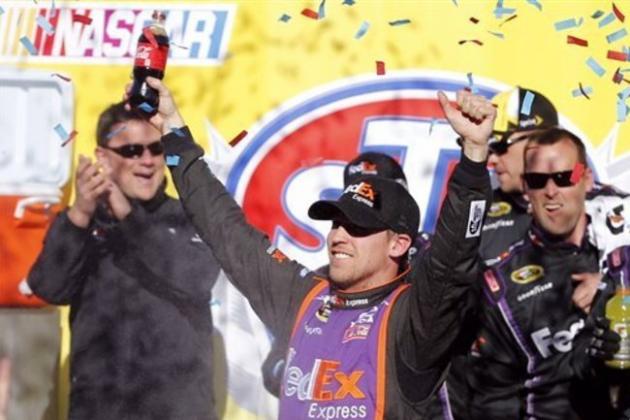 Denny Hamlin celebrates winning  the NASCAR Sprint Cup race at Martinsville Speedway in Martinsville, Va., Sunday, March 29, 2015. (AP Photo/Steve Helber)