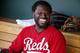 Cincinnati Reds' Brandon Phillips laughs in the dugout as he jokes around with teammates during the second inning of a spring training baseball game Wednesday, April 1, 2015, in Goodyear, Ariz. The Diamondbacks defeated the Reds 3-0. (AP Photo/Ross D. Franklin)