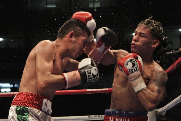 Mexico's Omar Salado, left, and Panama's Luis Concepcion, right, battle during their World Boxing Association interim flyweight title fight in Panama City, Saturday, Sept. 5, 2009. Concepcion won by technical KO during the 12th round. (AP Photo/Arnulfo Franco)