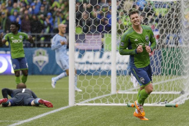 Seattle Sounders' Kenny Cooper, right, reacts after his shot on goal went just wide of the post in the second half of an MLS soccer match against Sporting Kansas City, Saturday, March 8, 2014, in Seattle. The Sounders beat Sporting KC 1-0. (AP Photo/Ted S. Warren)