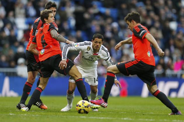 Real Madrid's Chicharito, center, tries to get through the Real Sociedad defense during a Spanish La Liga soccer match between Real Madrid and Real Sociedad at the Santiago Bernabeu stadium in Madrid, Spain, Saturday Jan. 31, 2015. (AP Photo/Paul White)