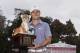 Jordan Spieth holds the championship trophy after winning the Hero World Challenge golf tournament on Sunday, Dec. 7, 2014, in Windermere, Fla. (AP Photo/Willie J. Allen Jr.)