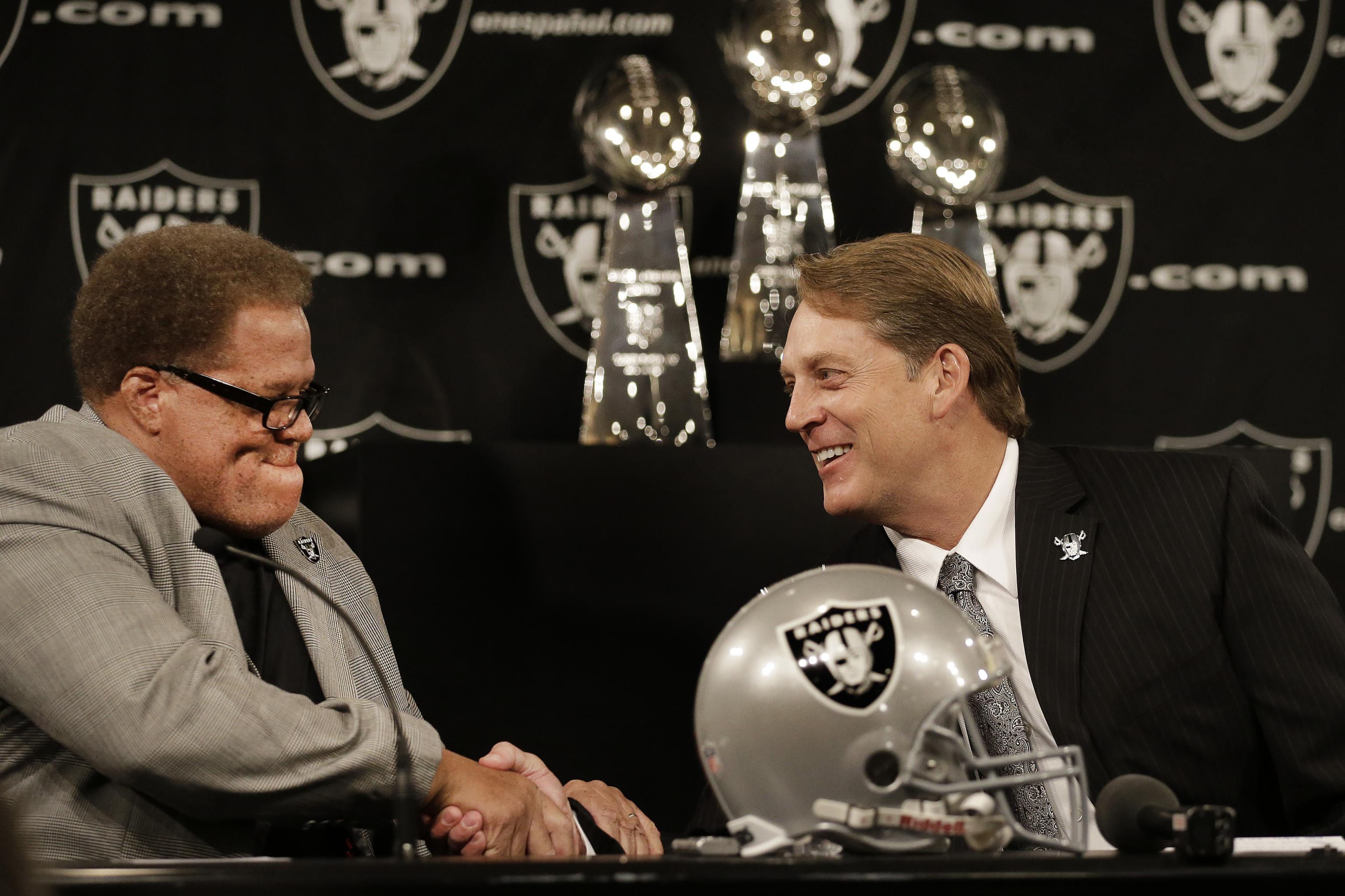 Oakland Raiders quarterback Derek Carr (4) and head coach Jack Del Rio  watch a replay during the second half of an NFL football game against the  San Diego Chargers in Oakland, Calif.