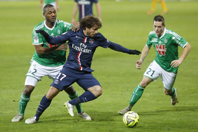 Paris Saint Germain's Maxwel Scherrer Cabelino Andrade, center, challenges for the ball with Saint-Etienne's Kevin Theophile Catherine, left, and Romain Hamouma, right, during their French League One soccer match in Saint-Etienne, central France, Sunday, Jan. 25, 2015. (AP Photo/Laurent Cipriani)