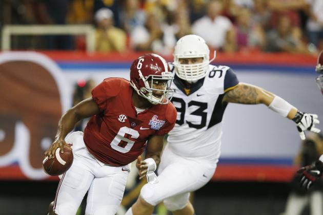 Alabama quarterback Blake Sims (6) scrambles away from West Virginia defensive lineman Kyle Rose (93) during the first half of an NCAA college football game Saturday, Aug. 30, 2014, in Atlanta.  (AP Photo/Bryn Anderson)