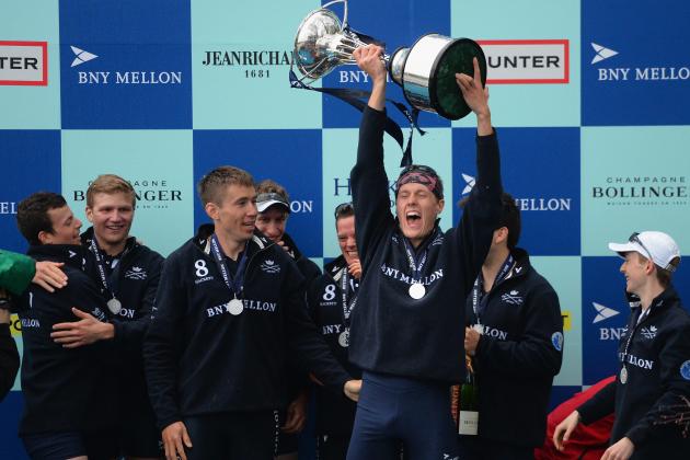 LONDON, ENGLAND - APRIL 06: Karl Hudspith of Oxford rises the trophy as he celebrates their victory with his team mates during the BNY Mellon Oxford v Cambridge University Boat Race 2014 on the Thames on April 6, 2014 in London, England. (Photo by Christopher Lee/Getty Images)