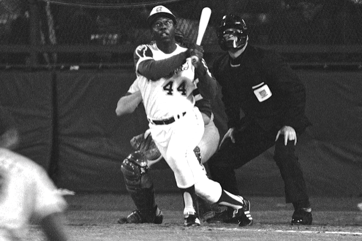 Outfielder Hank Aaron of the Atlanta Braves swings and watches the News  Photo - Getty Images