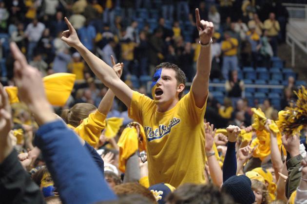 West Virginia student Brian Blend of Buckhannon, W.Va., celebrates with fans on the basketball court following the Mountaineers 70-65 win over No. 2 UCLA Saturday, Feb. 10, 2007 in Morgantown, W.Va. (AP Photo/Jeff Gentner)