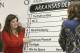 Sara Jeffers, left, and Hilari Burns place the name of thoroughbred American Pharoah in the sixth position in the post position draw for Saturday's running of the $1 million Arkansas Derby horse race at Oaklawn Park in Hot Springs, Ark., Wednesday, April 8, 2015. (AP Photo/Danny Johnston)