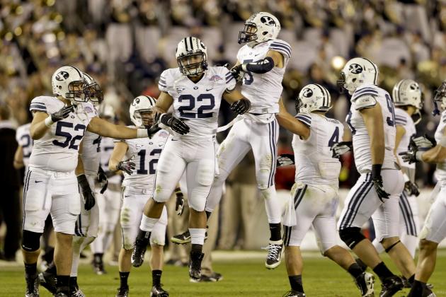 BYU players, including Manoa Pikula, (22), and Alani Fua, (5), celebrate after a fourth quarter turnover during their 23-6 victory over San Diego State in the Poinsettia Bowl NCAA college football game Thursday, Dec. 20, 2012, in San Diego. (AP Photo/Lenny Ignelzi)