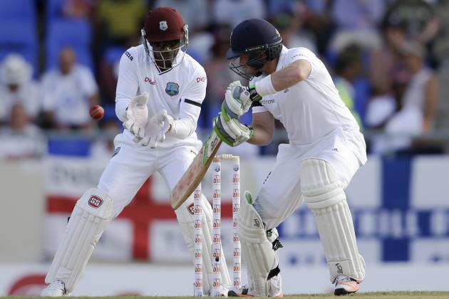 England's Ian Bell  hits a four off West Indies' Marlon Samuels to complete 102 runs during the opening day of their first cricket Test match at the Sir Vivian Richards Cricket Ground in Antigua, Antigua and Barbuda, Monday, April 13, 2015.  West Indies' wicket keeper Denesh Ramdin in in the back . (AP Photo/Ricardo Mazalan)