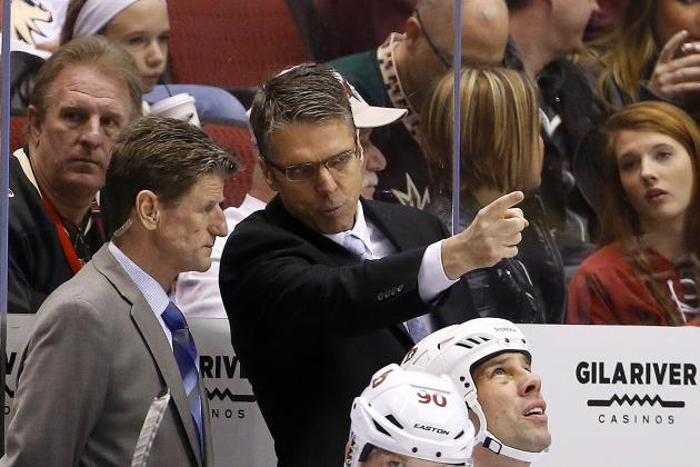 Ottawa Senators head coach Dave Cameron, right, points something out to assistant coach Mark Reeds, left, on the ice during the first period of an NHL hockey game against the Arizona Coyotes Saturday, Jan. 10, 2015, in Glendale, Ariz.  (AP Photo/Ross D. Franklin)