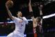 Oklahoma City Thunder center Enes Kanter (34) shoots as Toronto Raptors center Jonas Valanciunas (17) defends during an NBA basketball game between the Toronto Raptors and the Oklahoma City Thunder in Oklahoma City, Sunday, March 8, 2015. (AP Photo/Sue Ogrocki)