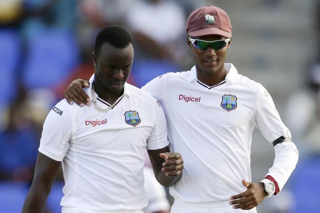 West Indies' Kraigg Brathwaite, right, embraces bowler Kemar Roach after his dismissal of England's Ian Bell during the opening day of the first cricket Test match at the Sir Vivian Richards Cricket Ground in Antigua, Antigua and Barbuda, Monday, April 13, 2015. (AP Photo/Ricardo Mazalan)