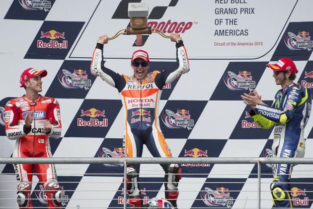 Marc Marquez, center, of Spain, center, celebrates his win with second position finisher Andrea Dovizioso, left, of Italy, and third position finisher Valentino Rossi, of Italy, after the MotoGP Grand Prix of the Americas motorcycle race, Sunday, April 12, 2015, at the Circuit of the Americas in Austin, Texas. (AP Photo/Darren Abate)