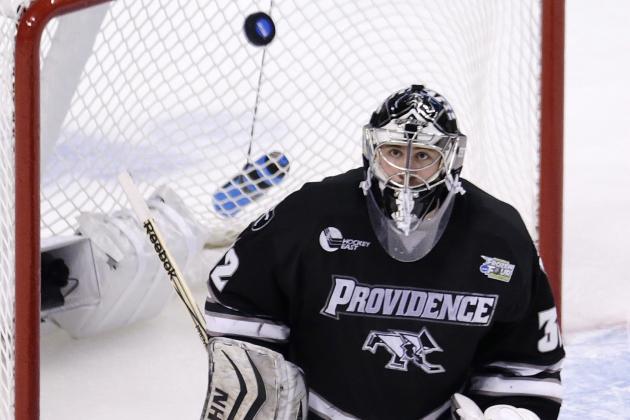 Providence goalie Jon Gillies eyes the puck on a shot by Omaha during the first period of their semi-final game at the NCAA Frozen Four hockey tournament in Boston, Thursday, April 9, 2015. (AP Photo/Charles Krupa)