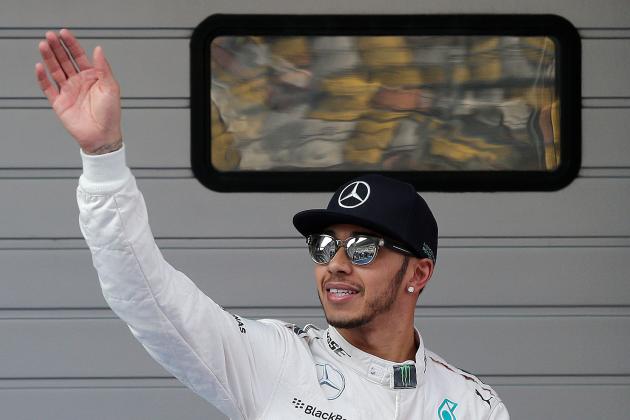 Mercedes driver Lewis Hamilton of Britain waves after taking pole in the qualifying session for the Chinese Formula One Grand Prix at Shanghai International Circuit in Shanghai, China, Saturday, April 11, 2015. (AP Photo/Andy Wong)