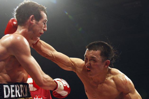 Boxer Choi Tseveenpurev of Mongolia, right, throws a punch at Britain's Derry Mathews, left, during their World Boxing Union Featherweight Championship fight in Bolton, England, Saturday, April 5, 2008. (AP Photo/Jon Super)