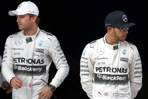 Mercedes driver Lewis Hamilton, right, of Britain stands next to teammate Nico Rosberg of Germany after taking pole in the qualifying session for the Chinese Formula One Grand Prix at Shanghai International Circuit in Shanghai, China, Saturday, April 11, 2015. Rosberg finished second for Sunday's race. (AP Photo/Andy Wong)