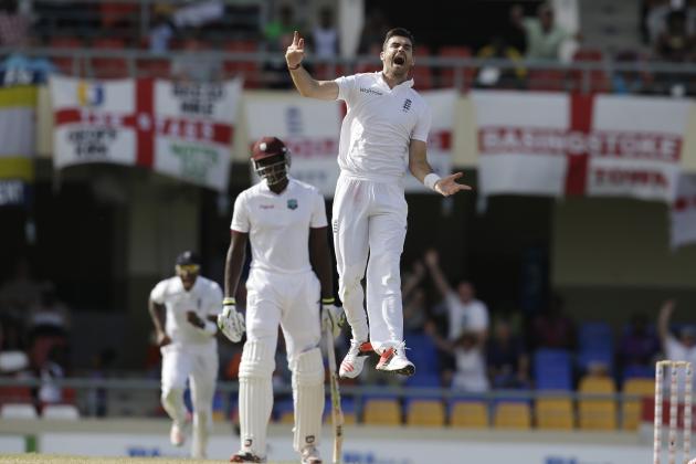 England's James Anderson celebrates taking the wicket of West Indies' Denesh Ramdin, under the look of West Indies' Jason Holder, background, on the last day of their first cricket Test match at the Sir Vivian Richards Cricket Ground in Antigua, Antigua and Barbuda, Friday, April 17, 2015.  nderson became the leading Test wicket-taker in England's cricket history. (AP Photo/Ricardo Mazalan)