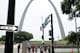 Pedestrians cross a street near the Gateway Arch Friday, Aug. 2, 2013, in St. Louis. The $380 million project to upgrade the grounds of the Gateway Arch officially began Friday as two members of President Barack Obama's Cabinet helped break ground. (AP Photo/Jim Salter)