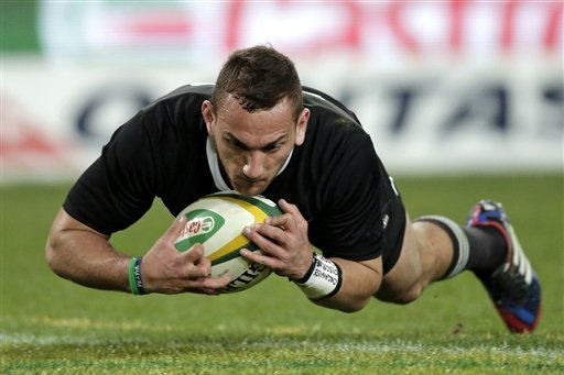 New Zealand's Aaron Cruden scores a try after gathering a ball he blocked a kick from Australia during their Bledisloe Cup rugby union match at the Olympic Stadium in Sydney, Australia, Saturday, Aug. 17, 2013.  (AP Photo/Rick Rycroft)