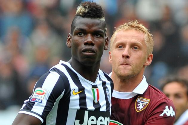 Juventus midfielder Paul Pogba, of France, and Torino defender Kamil Glik, of Poland, look at the ball, during a Serie A soccer match between Torino and Juventus at the Olympic stadium, in Turin, Italy, Sunday, Sept. 29, 2013. (AP Photo/Massimo Pinca)