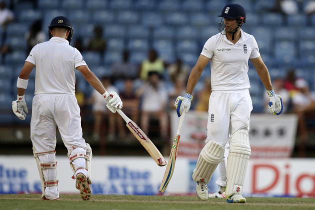 England's captain Alistair Cook, right, and teammate Jonathan Trott touch bats to celebrate runs during their partnership on day two of their second Test match against West Indies at the National Stadium in St. George's, Grenada, Wednesday, April 22, 2015. (AP Photo/Ricardo Mazalan)