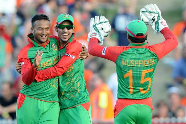 Bangladesh bowler Shakib Al Hasan, left, is congratulated by teammates Nasir Hossain  and  Mushfiqur Rahim, right, after taking the wicket of New Zealand’s Brendon McCullum during their Cricket World Cup Pool A match in Hamilton, New Zealand, Friday, March 13, 2015. (AP Photo/Ross Setford)