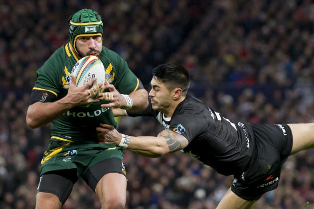 Australia's Johnathan Thurston, left, keeps the ball from New Zealand's Shaun Johnson during their World Cup Final International Rugby League match at Old Trafford Stadium, Manchester, England, Saturday Nov. 30, 2013. (AP Photo/Jon Super)
