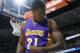 Los Angeles Lakers forward Ed Davis (21) flexes his arm after dunking the ball for a basket against the Denver Nuggets in the first quarter of an NBA basketball game Wednesday, April 8, 2015, in Denver. (AP Photo/David Zalubowski)