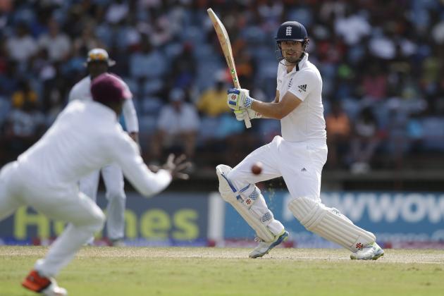 England's captain Alistair Cook plays a shot from the bowling of West Indies' Kemar Roach as West Indies' Kraigg Brathwaite, right, fields during day five of their second Test match at the National Stadium in St. George's, Grenada, Saturday, April 25, 2015. (AP Photo/Ricardo Mazalan)
