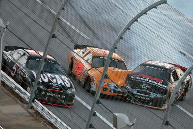 Austin Wayne Self, right, spins into Brad Smith (48) as Bobby Gerhart (5) passes them in the tri-oval during the ARCA Series auto race at Talladega Superspeedway, Friday, May 1, 2015, in Talladega, Ala. (AP Photo/Butch Dill)