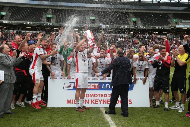 MILTON KEYNES, ENGLAND - MAY 03: MK Dons players celebrate after gaining promotion to the Championship at the end of the Sky Bet League One match between MK Dons and Yeovil Town at Stadium mk on May 3, 2015 in Milton Keynes, England. (Photo by Pete Norton/Getty Images)