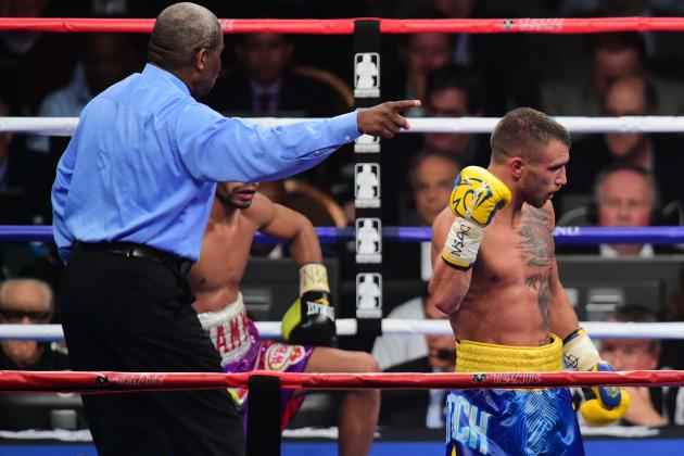 May 2, 2015; Las Vegas, NV, USA; Vasyl Lomachenko (blue/yellow trunks) knocks out Gamalier Rodriguez (purple trunks) during their WBO featherweight championship bout at MGM Grand Garden Arena. Mandatory Credit: Joe Camporeale-USA TODAY Sports