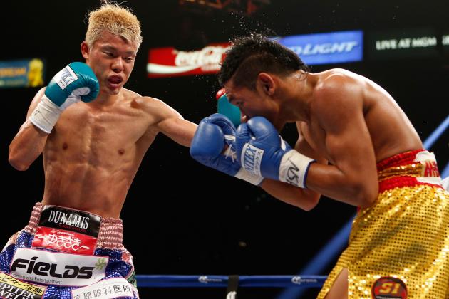 LAS VEGAS, NV - JULY 12:  (L-R) Tomoki Kameda lands a left against Pungluang Singyu during their WBO bantamweight title bout at the MGM Grand Garden Arena on July 12, 2014 in Las Vegas, Nevada.  Kameda defeated Singyu by seventh round knockout to retain his title.  (Photo by Josh Hedges/Getty Images)