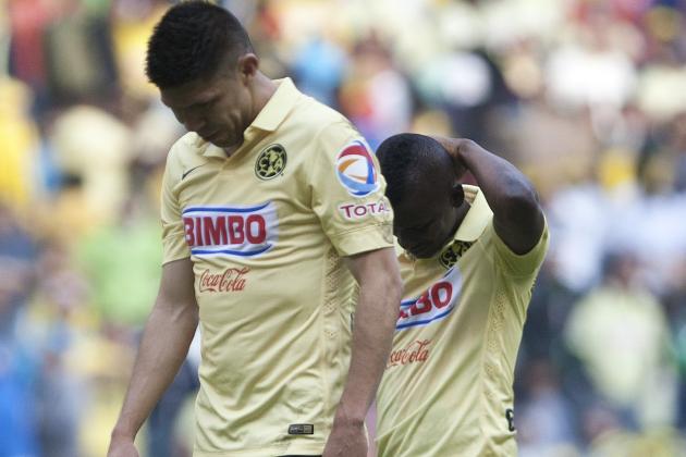 America's Oribe Peralta, left, and Carlos Quintero walk with their heads down after losing a Mexican soccer league match to Pachuca in Mexico City, Saturday, May 16, 2015. (AP Photo/Christian Palma)