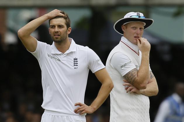 England's bowler Mark Wood, left, reacts as his teammate Ben Stokes looks on as a review shows that he had bowled a no ball to New Zealand's Martin Guptill, who had been caught at slip, but was give not out due to the no ball, during play on the second day of the first Test match at Lord's cricket ground in London, Friday, May 22, 2015. at right is England's Ben Stokes.(AP Photo/Kirsty Wigglesworth)
