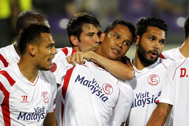 Sevilla's  Carlos Bacca, center, celebrates with teammates after scoring during an  Europa League semifinal, return match, between Fiorentina and Seville, at the Artemio Franchi stadium in Florence, Italy, Thursday, May 14, 2015.  (AP Photo/Fabrizio Giovannozzi)