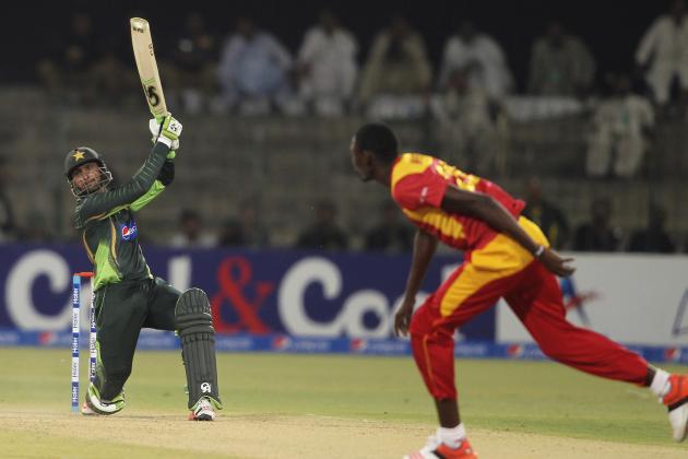 Pakistan's Shoaib Malik hits boundary as Zimbabwe's Christopher Mpofu looks on during a one-day international match at the Gaddafi Stadium in Lahore, Pakistan, Tuesday, May 26, 2015. Malik made an impressive return to limited-overs cricket with a blistering century on Tuesday, propelling Pakistan to 375-3 in the first one-day international against Zimbabwe. (AP Photo/K.M. Chaudary)