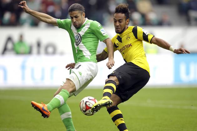 Wolfsburg's Ricardo Rodriguez from Switzerland, left, and Dortmund's Pierre-Emerick Aubameyang from Gabun, right, challenge for the ball during the German first division Bundesliga soccer match between VfL Wolfsburg and Borussia Dortmund in Wolfsburg, Germany, Saturday, May 16, 2015. (AP Photo/Michael Sohn)