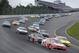 Kyle Larson (42) leads a pack of cars at the start of the NASCAR Sprint Cup Series auto race at Pocono Raceway, Sunday, Aug. 3, 2014, Long Pond, Pa. (AP Photo/Mel Evans)