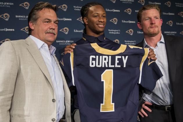 St. Louis Rams head coach Jeff Fisher, left, and general manager Les Snead, right, introduce first-round draft pick Todd Gurley during a news conference at the NFL football team's practice facility Friday, May 1, 2015, in St. Louis. Gurley, a running back from Georgia, was picked tenth overall by the Rams. (AP Photo/Whitney Curtis)