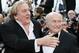 FILE - This is a Sunday, May 18, 2014 file photo of FIFA President Sepp Blatter, right, and actor Gerard Depardieu as they pose for photographers as they arrive for the screening of The Homesman at the 67th international film festival, Cannes, southern France. Funded with $27 million of FIFA money, the movie “United Passions” is acquiring almost mythical status in football circles. Mythical in the sense that the film, which was shown at the Zurich Film Festival on Sunday, has not been seen by many, and its relationship to documentary truth about FIFA’s troubled recent history is loose. In industry circles, “United Passions” would easily be defined as a box office flop _ even with star power from Gerard Depardieu, Sam Neill and Tim Roth. (AP Photo/Alastair Grant, File)