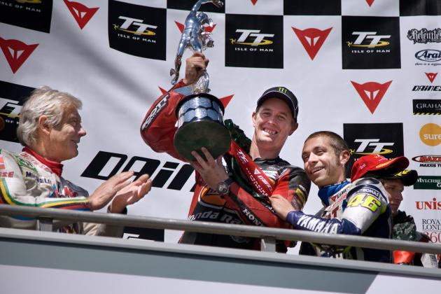 Italy’s Valentino Rossi, right, presents Britain's John McGuinness with the Trophy for winning the Isle of Man TT Superbike Race, on Monday June 8 2009. John McGuinness established himself as the second most successful Isle of Man Tourist Trophy rider of all time with victory in the Dainese Superbike race. The TT veteran was neck and neck with Mike Hailwood on 14 wins going into the opening race on the Isle of Man but a flawless ride saw the HM Plant Honda move to 15 and second outright. McGuinness' team-mate Steve Plater, winner of last year's Supersport race, claimed second - 18.55 seconds behind McGuinness with Hydrex Honda rider Guy Martin in third. (AP Photo/Pete Williamson)