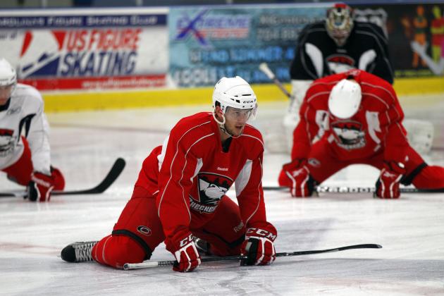 Brett Sutter, center, leads the team as players stretch during the opening hockey practice of the Charlotte Checkers training camp in Indian Trail, N.C., Saturday, Sept. 29, 2012. Several Carolina Hurricanes players are training with the Checkers, their AHL affiliate team, during the NHL lockout. (AP Photo/Chuck Burton)