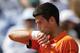Serbia's Novak Djokovic wipes his face as he plays Switzerland's Stan Wawrinka during their final match of the French Open tennis tournament at the Roland Garros stadium, Sunday, June 7, 2015 in Paris. (AP Photo/Francois Mori)