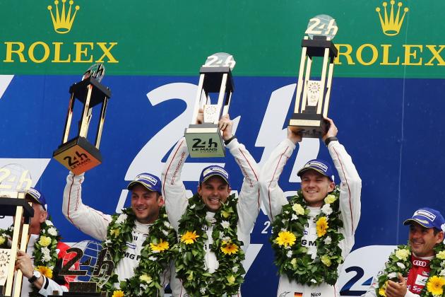 LE MANS, FRANCE - JUNE 14:  The Porsche Team 919 Hybrid of (L-R) Nick Tandy of Great Britain, Earl Bamber of New Zealand and Nico Hulkenburg of Germany celebrate on the podium after winning the Le Mans 24 Hour race at the Circuit de la Sarthe on June 14, 2015 in Le Mans, France.  (Photo by Ker Robertson/Getty Images)