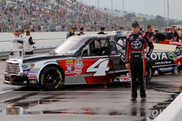 Erik Jones, right, stands near his race truck after a sudden burst of rain prior to a NASCAR Truck Series auto race at Gateway Motorsports Park, Saturday, June 13, 2015, in Madison, Ill. (AP Photo/Scott Kane)