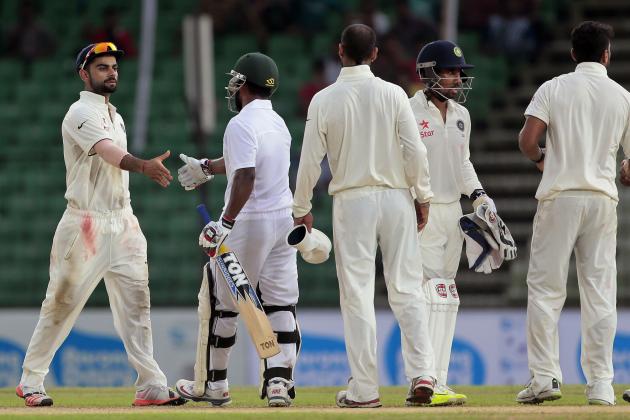 India’s captain Virat Kohli, left, shakes hand with Bangladesh’s Imrul Kayes, second left, at the end of the final day of their cricket test match in Fatullah, Bangladesh, Sunday, June 14, 2015. Match ended with a draw. (AP Photo/A.M. Ahad)